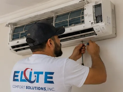 Elite Comfort Solutions technician installing a ductless mini-split indoor unit